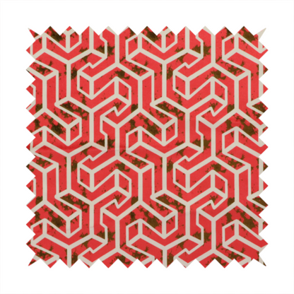 A red and off-white textile fabric featuring a repeating, interlocking geometric pattern. The design consists of off-white outlines forming three-dimensional, isometric maze-like structures against a vibrant coral red background. Distressed, dark brown speckled textures are subtly scattered throughout the red spaces, adding a weathered, organic touch to the structured, geometric design.
