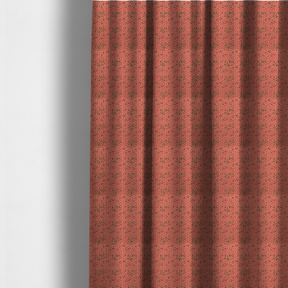The fabric used to create these made-to-measure curtains is a coral red and off-white textile fabric featuring a small-scale, densely repeating interlocking geometric pattern. Fine off-white outlines construct complex, three-dimensional isometric block formations against a vibrant coral red background. Distressed, dark brown speckled textures are integrated throughout, creating a weathered, organic contrast to the sharp geometric structure.
