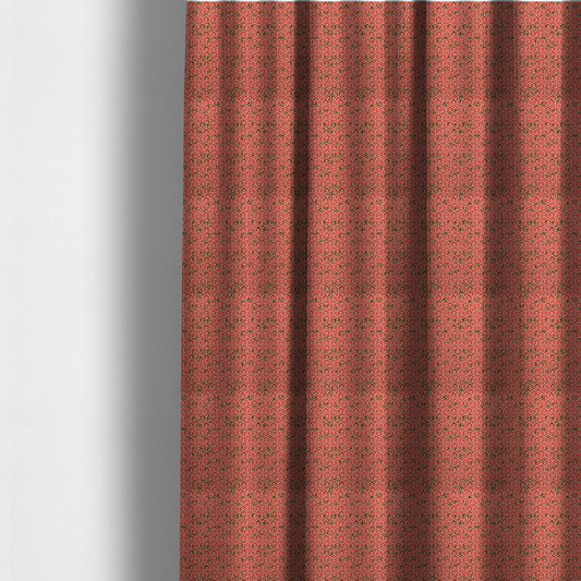 The fabric used to create these made-to-measure curtains is a coral red and off-white textile fabric featuring a small-scale, densely repeating interlocking geometric pattern. Fine off-white outlines construct complex, three-dimensional isometric block formations against a vibrant coral red background. Distressed, dark brown speckled textures are integrated throughout, creating a weathered, organic contrast to the sharp geometric structure.
