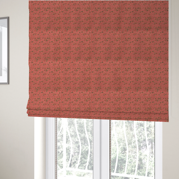 The fabric used to create these Roman blinds is a coral red and off-white textile fabric featuring a small-scale, densely repeating interlocking geometric pattern. Fine off-white outlines construct complex, three-dimensional isometric block formations against a vibrant coral red background. Distressed, dark brown speckled textures are integrated throughout, creating a weathered, organic contrast to the sharp geometric structure.