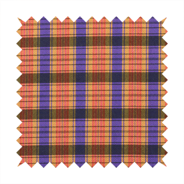 A vibrant, multi-coloured plaid fabric featuring a complex grid of horizontal and vertical stripes. The pattern blends deep indigo, golden ochre, and olive green, highlighted by thin, high-contrast stripes of bright violet and coral pink.