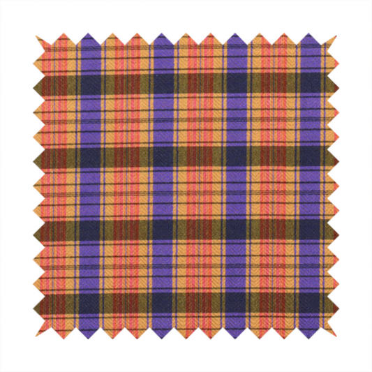A vibrant, multi-coloured plaid fabric featuring a complex grid of horizontal and vertical stripes. The pattern blends deep indigo, golden ochre, and olive green, highlighted by thin, high-contrast stripes of bright violet and coral pink.