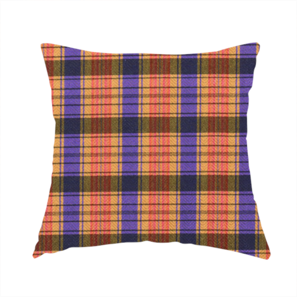 The fabric used to create this handmade cushion is a vibrant, multi-coloured plaid fabric featuring a complex grid of horizontal and vertical stripes. The pattern blends deep indigo, golden ochre, and olive green, highlighted by thin, high-contrast stripes of bright violet and coral pink.