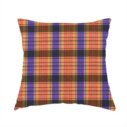 The fabric used to create this handmade cushion is a vibrant, multi-coloured plaid fabric featuring a complex grid of horizontal and vertical stripes. The pattern blends deep indigo, golden ochre, and olive green, highlighted by thin, high-contrast stripes of bright violet and coral pink.