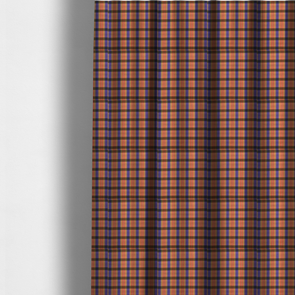 The fabric used to create these made-to-measure curtains is a vibrant, multi-coloured plaid fabric featuring a complex grid of horizontal and vertical stripes. The pattern blends deep indigo, golden ochre, and olive green, highlighted by thin, high-contrast stripes of bright violet and coral pink.