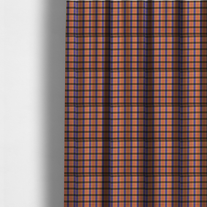 The fabric used to create these made-to-measure curtains is a vibrant, multi-coloured plaid fabric featuring a complex grid of horizontal and vertical stripes. The pattern blends deep indigo, golden ochre, and olive green, highlighted by thin, high-contrast stripes of bright violet and coral pink.