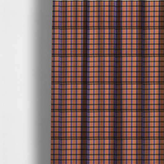 The fabric used to create these made-to-measure curtains is a vibrant, multi-coloured plaid fabric featuring a complex grid of horizontal and vertical stripes. The pattern blends deep indigo, golden ochre, and olive green, highlighted by thin, high-contrast stripes of bright violet and coral pink.