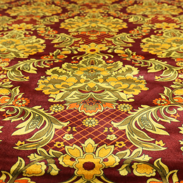 An ornate damask fabric featuring large, symmetrical floral medallions in shades of sage green, golden ochre, and muted orange.