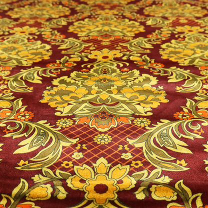 An ornate damask fabric featuring large, symmetrical floral medallions in shades of sage green, golden ochre, and muted orange.