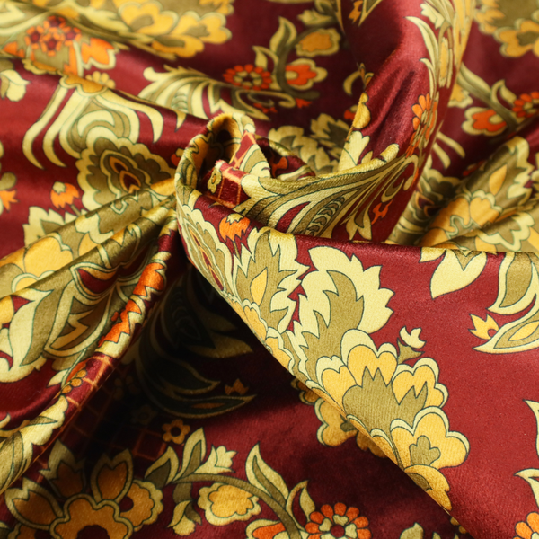 An ornate damask fabric featuring large, symmetrical floral medallions in shades of sage green, golden ochre, and muted orange.