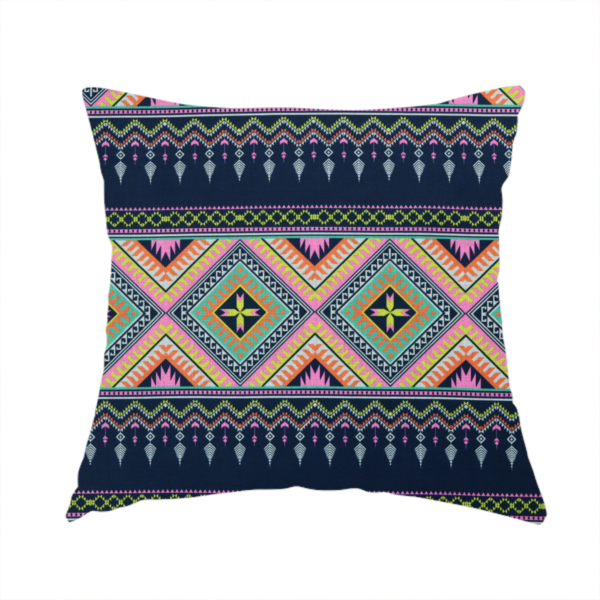 The fabric used to create this handmade cushion is a vibrant, repeating geometric Aztec or tribal fabric pattern organized in horizontal bands. The design features alternating wide stripes of colourful diamond and zigzag motifs against narrower dark navy bands filled with intricate chevron and tassel-like embroidery accents.