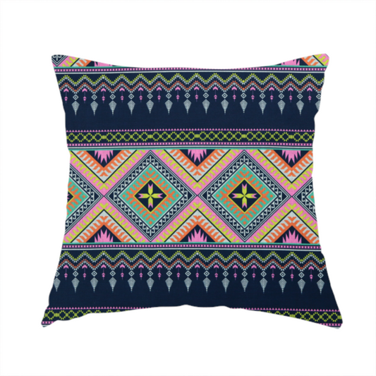 The fabric used to create this handmade cushion is a vibrant, repeating geometric Aztec or tribal fabric pattern organized in horizontal bands. The design features alternating wide stripes of colourful diamond and zigzag motifs against narrower dark navy bands filled with intricate chevron and tassel-like embroidery accents.