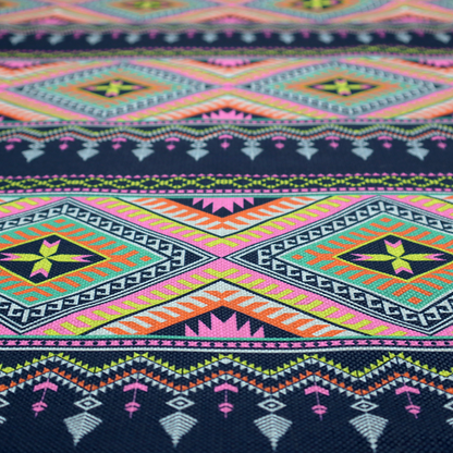 A vibrant, repeating geometric Aztec or tribal fabric pattern organized in horizontal bands. The design features alternating wide stripes of colourful diamond and zigzag motifs against narrower dark navy bands filled with intricate chevron and tassel-like embroidery accents.