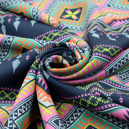 A vibrant, repeating geometric Aztec or tribal fabric pattern organized in horizontal bands. The design features alternating wide stripes of colourful diamond and zigzag motifs against narrower dark navy bands filled with intricate chevron and tassel-like embroidery accents.