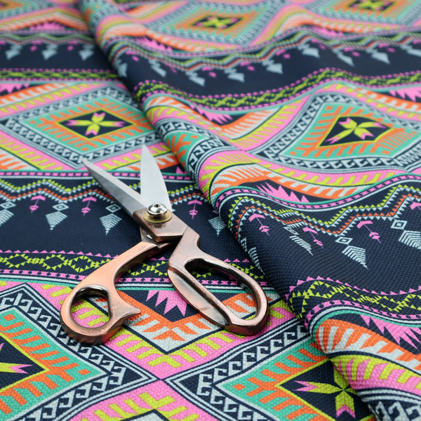 A vibrant, repeating geometric Aztec or tribal fabric pattern organized in horizontal bands. The design features alternating wide stripes of colourful diamond and zigzag motifs against narrower dark navy bands filled with intricate chevron and tassel-like embroidery accents.
