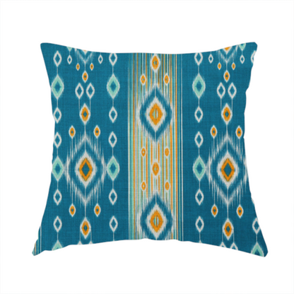 The fabric used to create this handmade cushion is a seamless, vertically striped ikat fabric pattern with traditional blurred or feathered edges set against a rich teal backdrop.