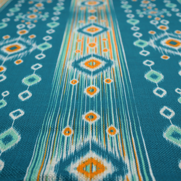 A seamless, vertically striped ikat fabric pattern with traditional blurred or feathered edges set against a rich teal backdrop.