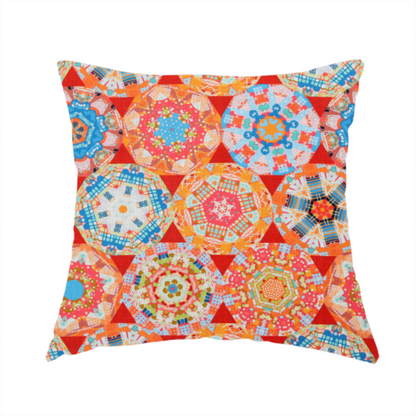 The fabric used to create this handmade cushion is a vibrant, kaleidoscope-inspired fabric pattern composed of interlocking circular and octagonal medallions set against a rich, fiery red-orange background.