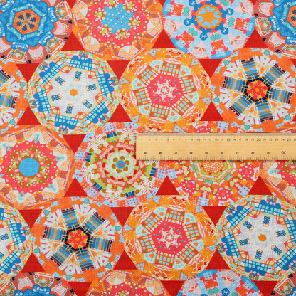 A vibrant, kaleidoscope-inspired fabric pattern composed of interlocking circular and octagonal medallions set against a rich, fiery red-orange background.