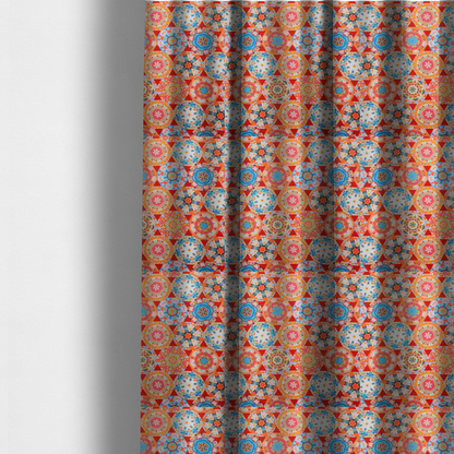 The fabric used to create these made-to-measure curtains is a vibrant, kaleidoscope-inspired fabric pattern composed of interlocking circular and octagonal medallions set against a rich, fiery red-orange background.