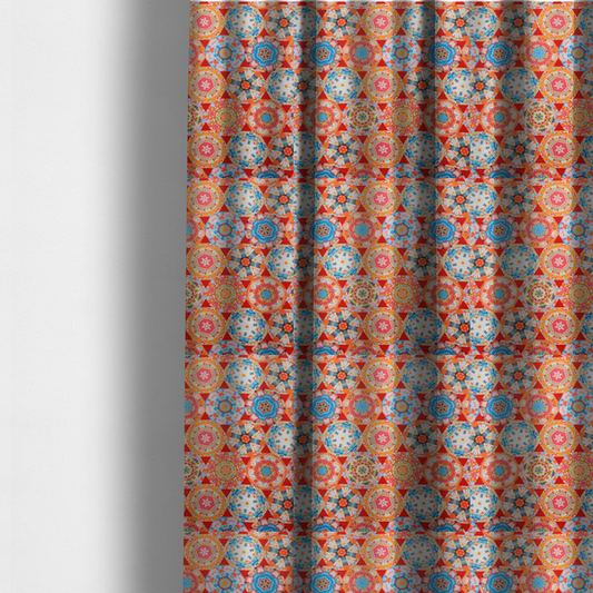 The fabric used to create these made-to-measure curtains is a vibrant, kaleidoscope-inspired fabric pattern composed of interlocking circular and octagonal medallions set against a rich, fiery red-orange background.