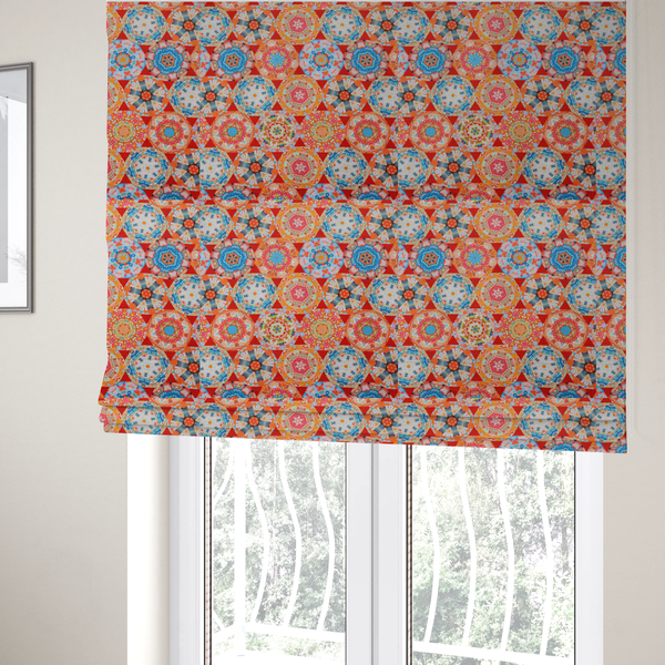 The fabric used to create these Roman blinds is a vibrant, kaleidoscope-inspired fabric pattern composed of interlocking circular and octagonal medallions set against a rich, fiery red-orange background.