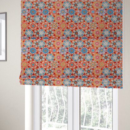 The fabric used to create these Roman blinds is a vibrant, kaleidoscope-inspired fabric pattern composed of interlocking circular and octagonal medallions set against a rich, fiery red-orange background.