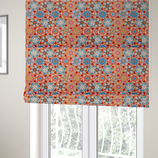 The fabric used to create these Roman blinds is a vibrant, kaleidoscope-inspired fabric pattern composed of interlocking circular and octagonal medallions set against a rich, fiery red-orange background.