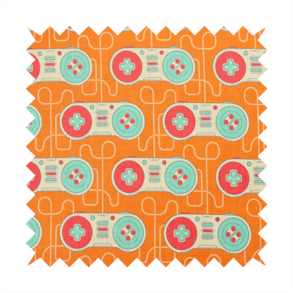 A playful, retro-inspired repeating fabric pattern featuring classic video game controllers connected by winding cord lines set against a warm orange background.