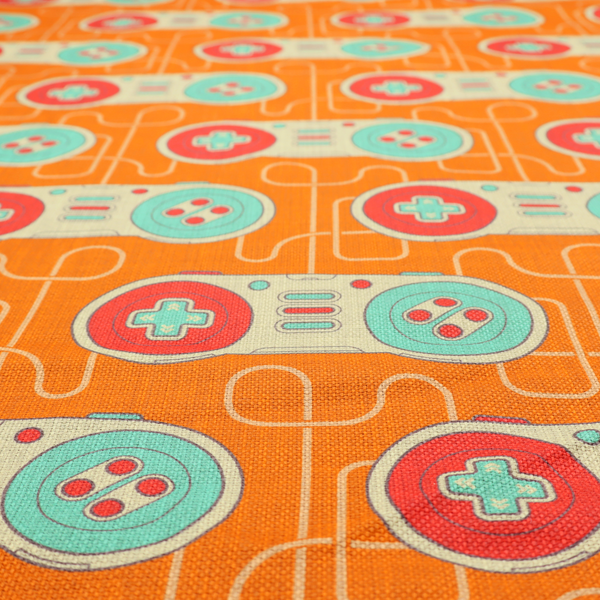 A playful, retro-inspired repeating fabric pattern featuring classic video game controllers connected by winding cord lines set against a warm orange background.