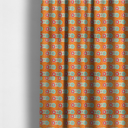 The fabric used to create these made-to-measure curtains is a playful, retro-inspired repeating fabric pattern featuring classic video game controllers connected by winding cord lines set against a warm orange background.