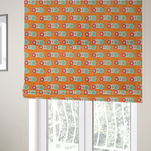 The fabric used to create these Roman blinds is a playful, retro-inspired repeating fabric pattern featuring classic video game controllers connected by winding cord lines set against a warm orange background.