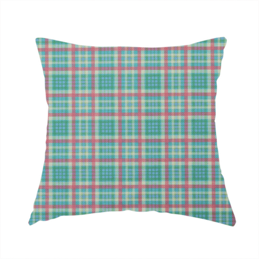 The fabric used to create this handmade cushion is a fabric features a woven plaid pattern consisting of intersecting horizontal and vertical stripes in shades of teal, soft pink, light blue, and cream. The pattern creates a series of repeated squares and rectangles across the surface.
