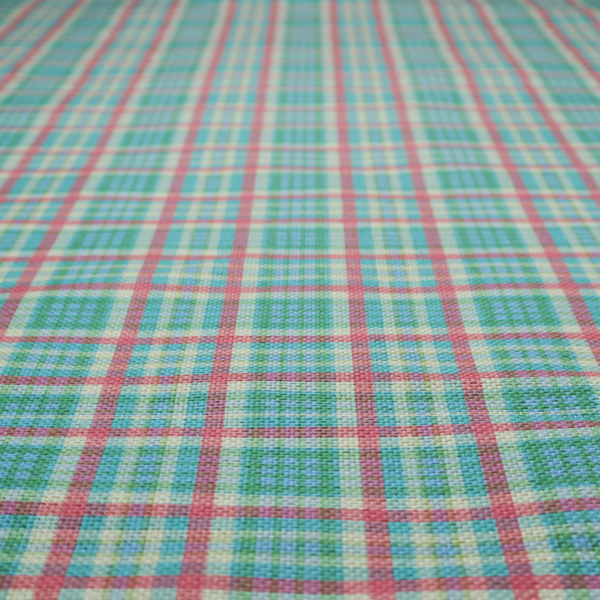 This fabric features a woven plaid pattern consisting of intersecting horizontal and vertical stripes in shades of teal, soft pink, light blue, and cream. The pattern creates a series of repeated squares and rectangles across the surface.
