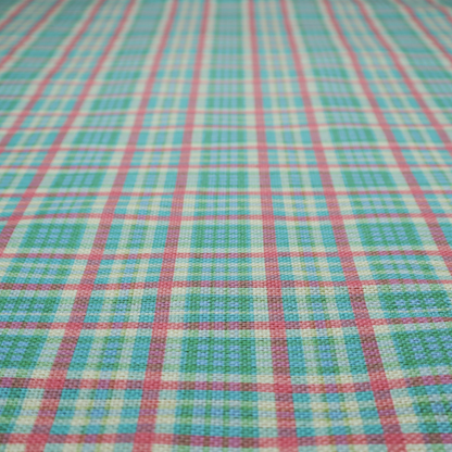 This fabric features a woven plaid pattern consisting of intersecting horizontal and vertical stripes in shades of teal, soft pink, light blue, and cream. The pattern creates a series of repeated squares and rectangles across the surface.