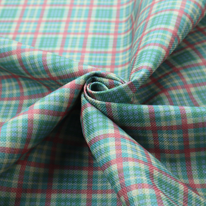 This fabric features a woven plaid pattern consisting of intersecting horizontal and vertical stripes in shades of teal, soft pink, light blue, and cream. The pattern creates a series of repeated squares and rectangles across the surface.