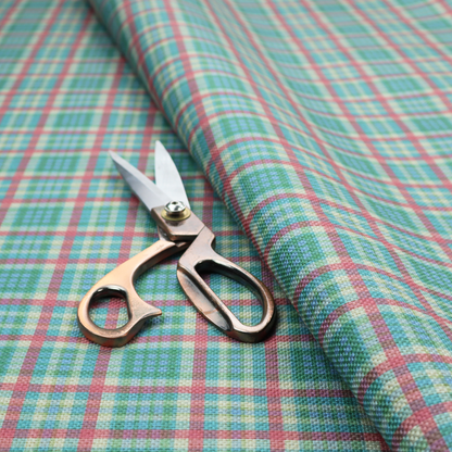 This fabric features a woven plaid pattern consisting of intersecting horizontal and vertical stripes in shades of teal, soft pink, light blue, and cream. The pattern creates a series of repeated squares and rectangles across the surface.