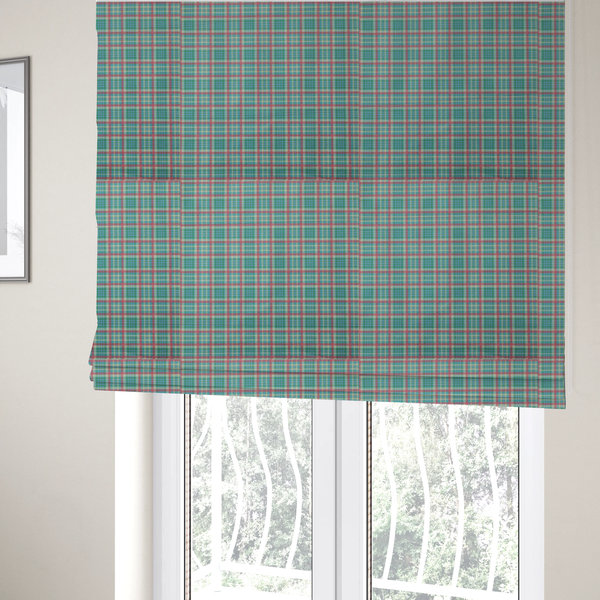 The fabric used to create these Roman blinds is a fabric features a woven plaid pattern consisting of intersecting horizontal and vertical stripes in shades of teal, soft pink, light blue, and cream. The pattern creates a series of repeated squares and rectangles across the surface.
