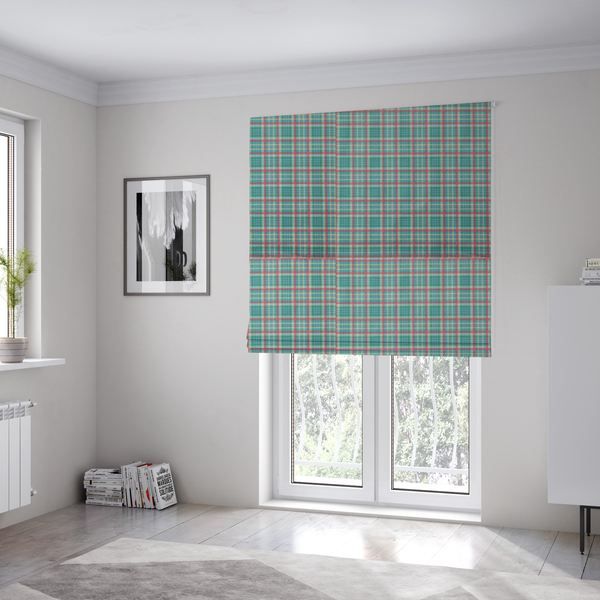 The fabric used to create these Roman blinds is a fabric features a woven plaid pattern consisting of intersecting horizontal and vertical stripes in shades of teal, soft pink, light blue, and cream. The pattern creates a series of repeated squares and rectangles across the surface.