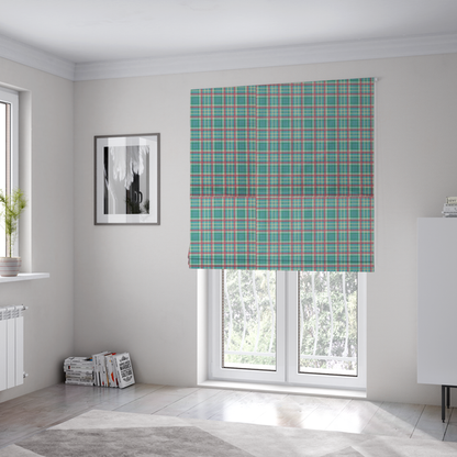 The fabric used to create these Roman blinds is a fabric features a woven plaid pattern consisting of intersecting horizontal and vertical stripes in shades of teal, soft pink, light blue, and cream. The pattern creates a series of repeated squares and rectangles across the surface.