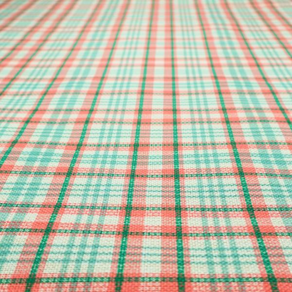 This fabric features a woven plaid pattern with a grid of intersecting horizontal and vertical stripes in coral, aqua, and dark green over a cream-colored background.