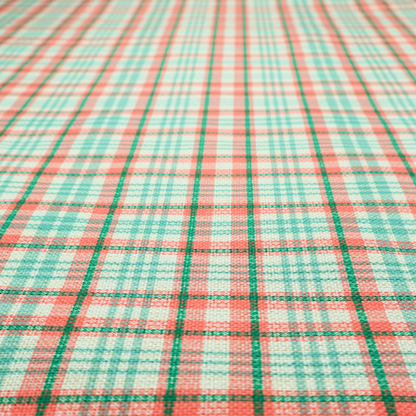 This fabric features a woven plaid pattern with a grid of intersecting horizontal and vertical stripes in coral, aqua, and dark green over a cream-colored background.