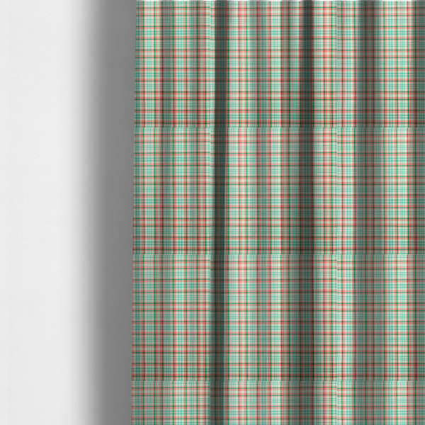 The fabric used to create these made-to-measure curtains is a fabric features a woven plaid pattern with a grid of intersecting horizontal and vertical stripes in coral, aqua, and dark green over a cream-colored background.