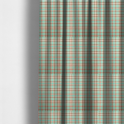 The fabric used to create these made-to-measure curtains is a fabric features a woven plaid pattern with a grid of intersecting horizontal and vertical stripes in coral, aqua, and dark green over a cream-colored background.