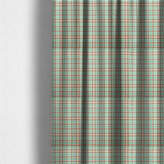 The fabric used to create these made-to-measure curtains is a fabric features a woven plaid pattern with a grid of intersecting horizontal and vertical stripes in coral, aqua, and dark green over a cream-colored background.
