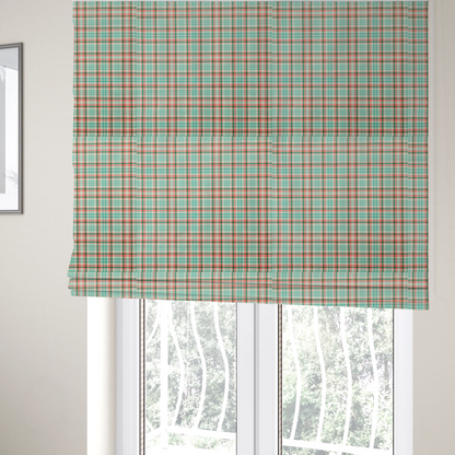 The fabric used to create these Roman blinds is a fabric features a woven plaid pattern with a grid of intersecting horizontal and vertical stripes in coral, aqua, and dark green over a cream-colored background.