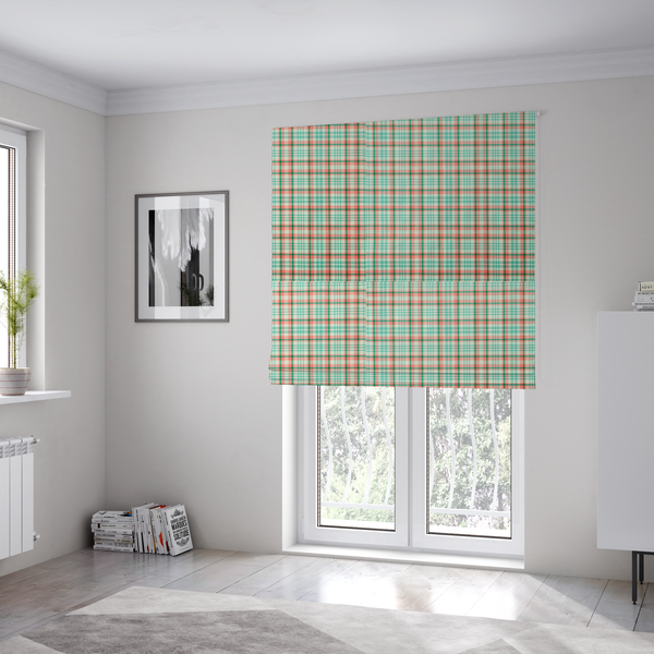 The fabric used to create these Roman blinds is a fabric features a woven plaid pattern with a grid of intersecting horizontal and vertical stripes in coral, aqua, and dark green over a cream-colored background.