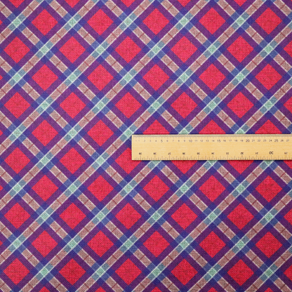 This fabric features a diagonal plaid pattern, creating a diamond-shaped grid. The design is composed of bold magenta squares framed by dark blue and thin white intersecting lines.