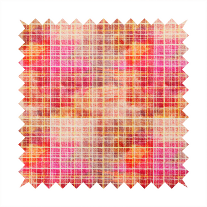 This fabric features an intricate, layered plaid pattern that blends warm tones of red, orange, yellow, and deep pink. The design has a slightly blurred, watercolour effect with a dense grid of fine white and gold lines overlapping the vibrant colours.