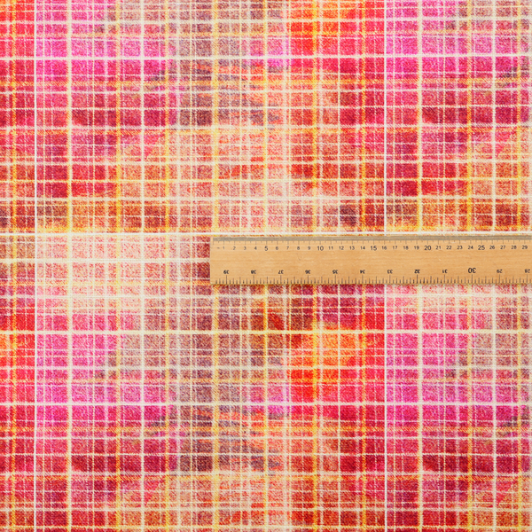 This fabric features an intricate, layered plaid pattern that blends warm tones of red, orange, yellow, and deep pink. The design has a slightly blurred, watercolour effect with a dense grid of fine white and gold lines overlapping the vibrant colours.